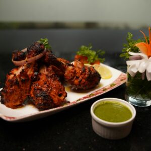 Spicy tandoori chicken served with refreshing green chutney and garnish.